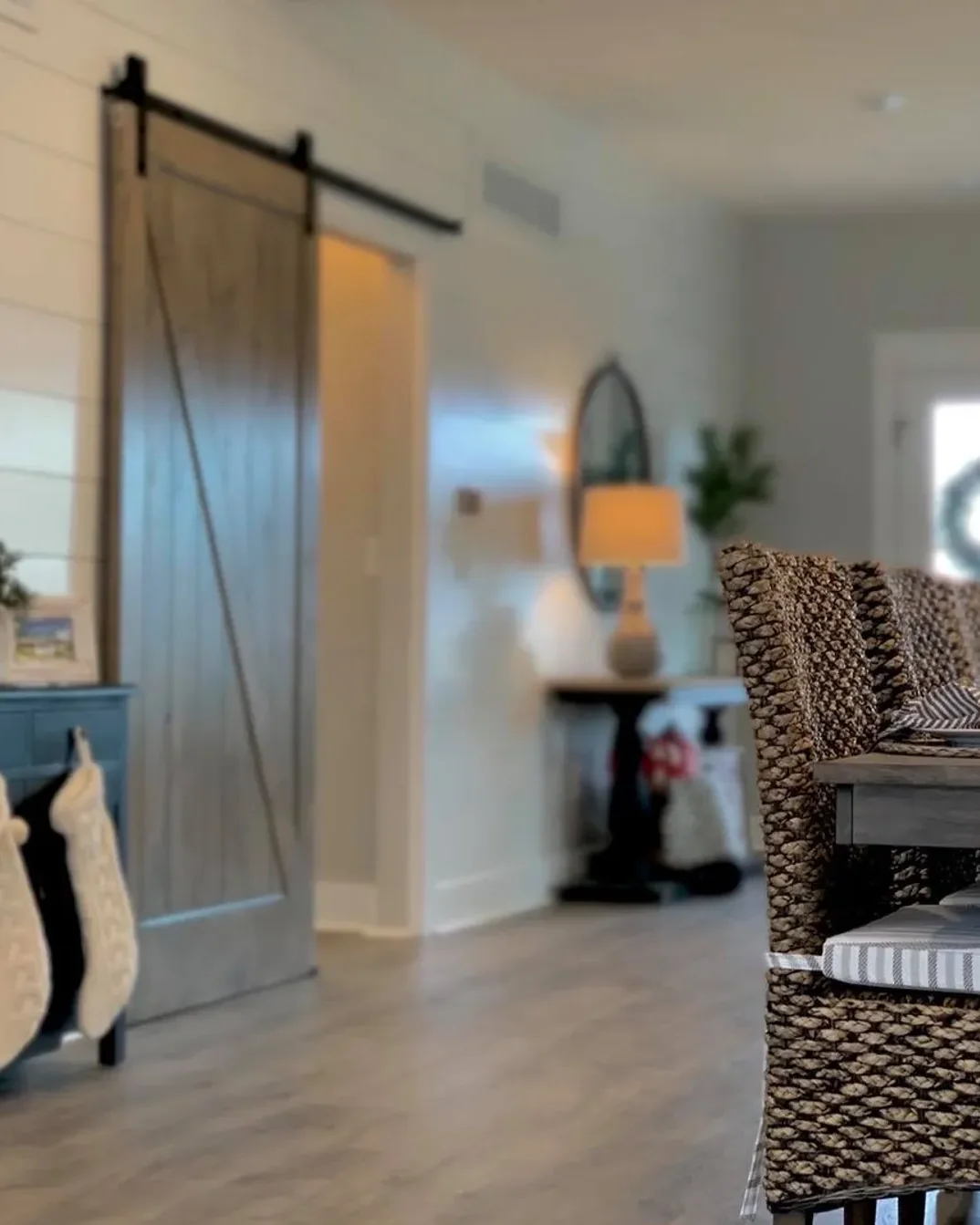 An entry hall in a finished Beracah home with a sliding barn door and a console table.