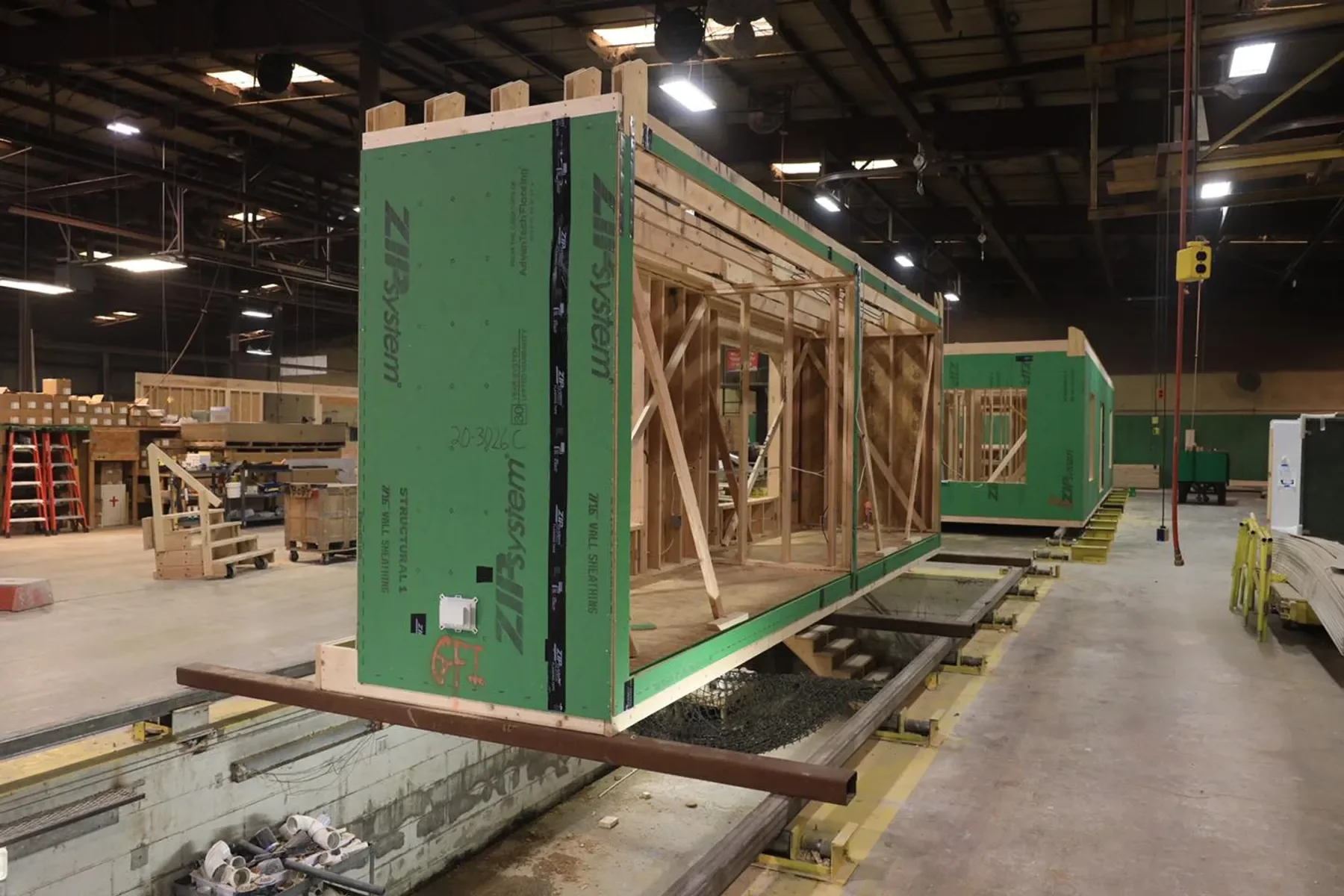 A framed and sheathed Beracah module standing on the factory floor in Greenwood, Delaware.